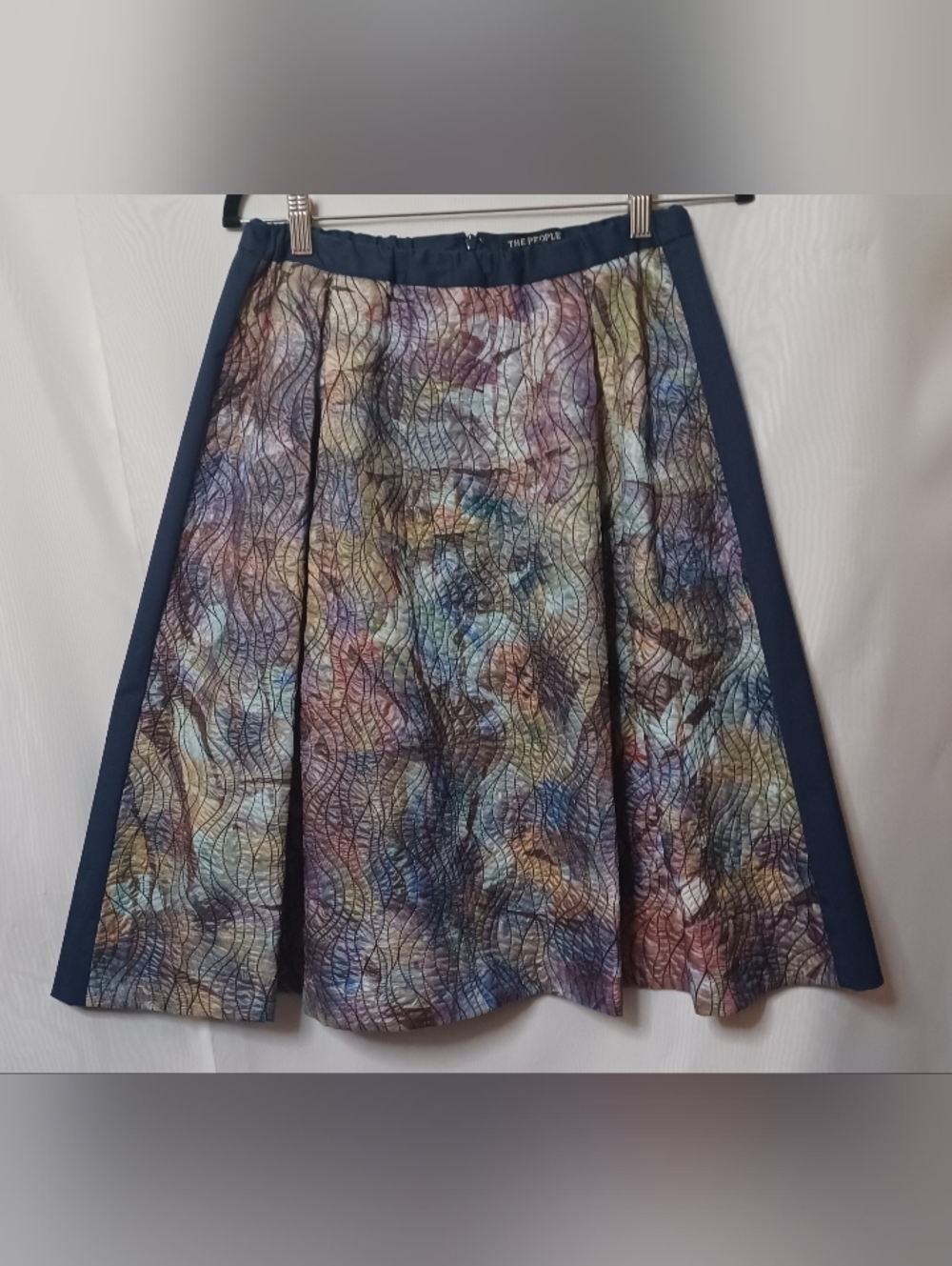 The People's Multi-color Pattern Pleated Front with Navy Back Skirt. Size 12